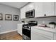 Bright kitchen features white cabinetry, stainless steel appliances, and a sleek, modern design with light gray walls at 4105 Ashton View Ln, Indianapolis, IN 46268