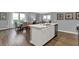 Open-concept kitchen and dining area featuring a kitchen island with a sink, seating, and stainless steel appliances at 4105 Ashton View Ln, Indianapolis, IN 46268