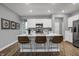 Bright, modern kitchen with an island, seating, stainless steel appliances and crisp white cabinetry at 4105 Ashton View Ln, Indianapolis, IN 46268