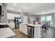 Spacious open kitchen featuring stainless steel appliances, quartz countertops, and an island with a sink at 4105 Ashton View Ln, Indianapolis, IN 46268