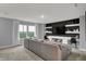 Spacious living area with large windows, a comfortable sofa, and a built-in entertainment center with stylish decor at 4105 Ashton View Ln, Indianapolis, IN 46268