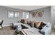 Modern living room with an oversized gray sectional sofa, decorative pillows, and stylish wall art at 4105 Ashton View Ln, Indianapolis, IN 46268