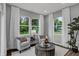 Inviting living room with armchairs, bright windows, and neutral tones, creating a relaxing atmosphere at 4105 Ashton View Ln, Indianapolis, IN 46268