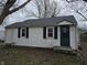 Charming one-story home with white siding, black shutters, and a well-maintained yard at 4210 E Naomi St, Indianapolis, IN 46203