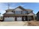 Charming two-story home featuring a brick facade, attached two-car garage and covered entryway at 4235 Brocket Dr, Greenwood, IN 46143