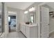 Well-lit bathroom with double sink vanity, large mirror, and a doorway leading to the bedroom and closet at 4330 Persian St, Greenwood, IN 46143