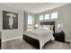 Relaxing bedroom featuring plush carpet, neutral colors, and ample natural light from multiple windows overlooking green space at 4330 Persian St, Greenwood, IN 46143