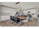 Dining room shows hardwood floors, modern chandelier and adjacent breakfast bar with lots of natural light at 4330 Persian St, Greenwood, IN 46143
