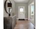 Inviting entryway with wood floors, decorative console, mirror, and bright natural light at 4330 Persian St, Greenwood, IN 46143