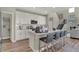 Bright kitchen features an island with bar seating, sleek appliances, and white cabinets at 4330 Persian St, Greenwood, IN 46143