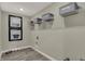 Functional laundry room with overhead shelving, sleek gray flooring, and stylish decor at 4330 Persian St, Greenwood, IN 46143