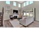 Cozy living room with a fireplace, plush seating, and abundant natural light from large windows at 4330 Persian St, Greenwood, IN 46143