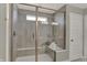 Bright, tiled shower with a glass door, built-in bench, and convenient shelving for toiletries at 4330 Persian St, Greenwood, IN 46143