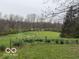 A beautifully landscaped backyard of this home surrounded by nature at 4491 W Stones Crossing Rd, Greenwood, IN 46143