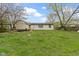 Lawn and yard featuring shed and the rear of the home at 4505 Phoenix Dr, Indianapolis, IN 46241
