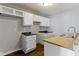 A kitchen featuring white cabinetry, countertops, and a double basin sink at 4505 Phoenix Dr, Indianapolis, IN 46241