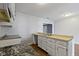 A kitchen showcasing a stainless steel sink with a pull down faucet and white cabinetry at 4505 Phoenix Dr, Indianapolis, IN 46241