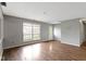 Bright living room featuring gray walls and hardwood flooring with a clear view to the front yard at 4505 Phoenix Dr, Indianapolis, IN 46241