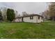 Back exterior of ranch-style house with a wood deck and an expansive, well-manicured yard at 5510 Chelsea Rd, Indianapolis, IN 46241