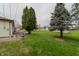 Backyard of a ranch-style house with a wood deck and an expansive, well-manicured yard at 5510 Chelsea Rd, Indianapolis, IN 46241