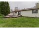 Back exterior of ranch-style house with a wood deck and an expansive, well-manicured yard at 5510 Chelsea Rd, Indianapolis, IN 46241