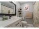 Well-lit bathroom featuring a modern vanity, toilet, and bathtub with a shower at 5510 Chelsea Rd, Indianapolis, IN 46241