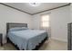 Relaxing bedroom retreat with neutral decor, a comfortable bed, and a bright window at 5510 Chelsea Rd, Indianapolis, IN 46241