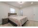 Sunlit bedroom with modern fan, natural light, queen bed, and wooden nightstand at 5510 Chelsea Rd, Indianapolis, IN 46241