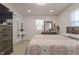 Bedroom featuring light floors, a queen bed, and dresser with a mirror at 5510 Chelsea Rd, Indianapolis, IN 46241