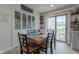 Dining area features a table with seating for six, illuminated by natural light from a sliding glass door at 5510 Chelsea Rd, Indianapolis, IN 46241