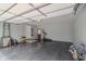 Spacious garage interior with painted walls and a door leading to the outside and including storage and exercise equipment at 5510 Chelsea Rd, Indianapolis, IN 46241