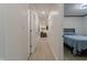 Bright hallway featuring white walls and wood-look flooring that leads to a bedroom and living area at 5510 Chelsea Rd, Indianapolis, IN 46241