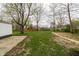 Spacious backyard with lush grass and mature trees, creating a serene outdoor space at 5516 S Randolph St, Indianapolis, IN 46227