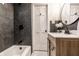 Modern bathroom featuring dark tile, a stylish vanity, and a soaking tub for a relaxing experience at 5516 S Randolph St, Indianapolis, IN 46227