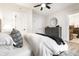 Well-lit primary bedroom with ceiling fan, closet, and updated bathroom entrance at 5516 S Randolph St, Indianapolis, IN 46227