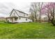 Charming two-story home with a well-manicured lawn and blossoming trees, offering curb appeal at 5516 S Randolph St, Indianapolis, IN 46227