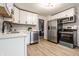 Modern kitchen with white cabinets, stainless steel appliances, and a stylish black and white backsplash at 5516 S Randolph St, Indianapolis, IN 46227