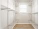Walk-in closet with custom shelving system and laminate wood floors at 5516 S Randolph St, Indianapolis, IN 46227