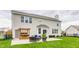 Home exterior showcasing the patio with grill and outdoor seating overlooking the backyard at 559 Hythe Way, Westfield, IN 46074