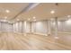 Large open basement with vinyl flooring, bright lighting, and painted support beams at 559 Hythe Way, Westfield, IN 46074