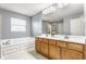 Bright bathroom with double sink vanity, soaking tub, and a window bringing in natural light at 559 Hythe Way, Westfield, IN 46074