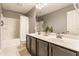 Bathroom with a double sink vanity, tile floor, and shower with white shower curtain at 559 Hythe Way, Westfield, IN 46074