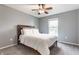 Bedroom with a comfortable bed, ceiling fan, and window allowing natural light to filter in at 559 Hythe Way, Westfield, IN 46074