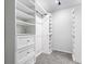 Organized walk-in closet with custom shelving, drawers, and carpeted floor for ample storage at 559 Hythe Way, Westfield, IN 46074