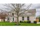 Two-story brick home has a manicured front yard, arched entryway, and a tree in front at 559 Hythe Way, Westfield, IN 46074
