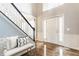 Spacious foyer features hardwood floors, staircase with runner, and front door with sidelights at 559 Hythe Way, Westfield, IN 46074