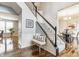 Bright foyer with hardwood floors, stairway with decorative spindles and adjacent dining area at 559 Hythe Way, Westfield, IN 46074