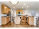 Bright kitchen featuring stainless steel appliances, wood cabinetry, and a center island at 559 Hythe Way, Westfield, IN 46074