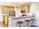Eat-in kitchen features a breakfast bar with seating and stainless steel appliances at 559 Hythe Way, Westfield, IN 46074