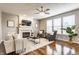 Cozy living room with fireplace, ceiling fan, hardwood floors and bright natural light at 559 Hythe Way, Westfield, IN 46074
